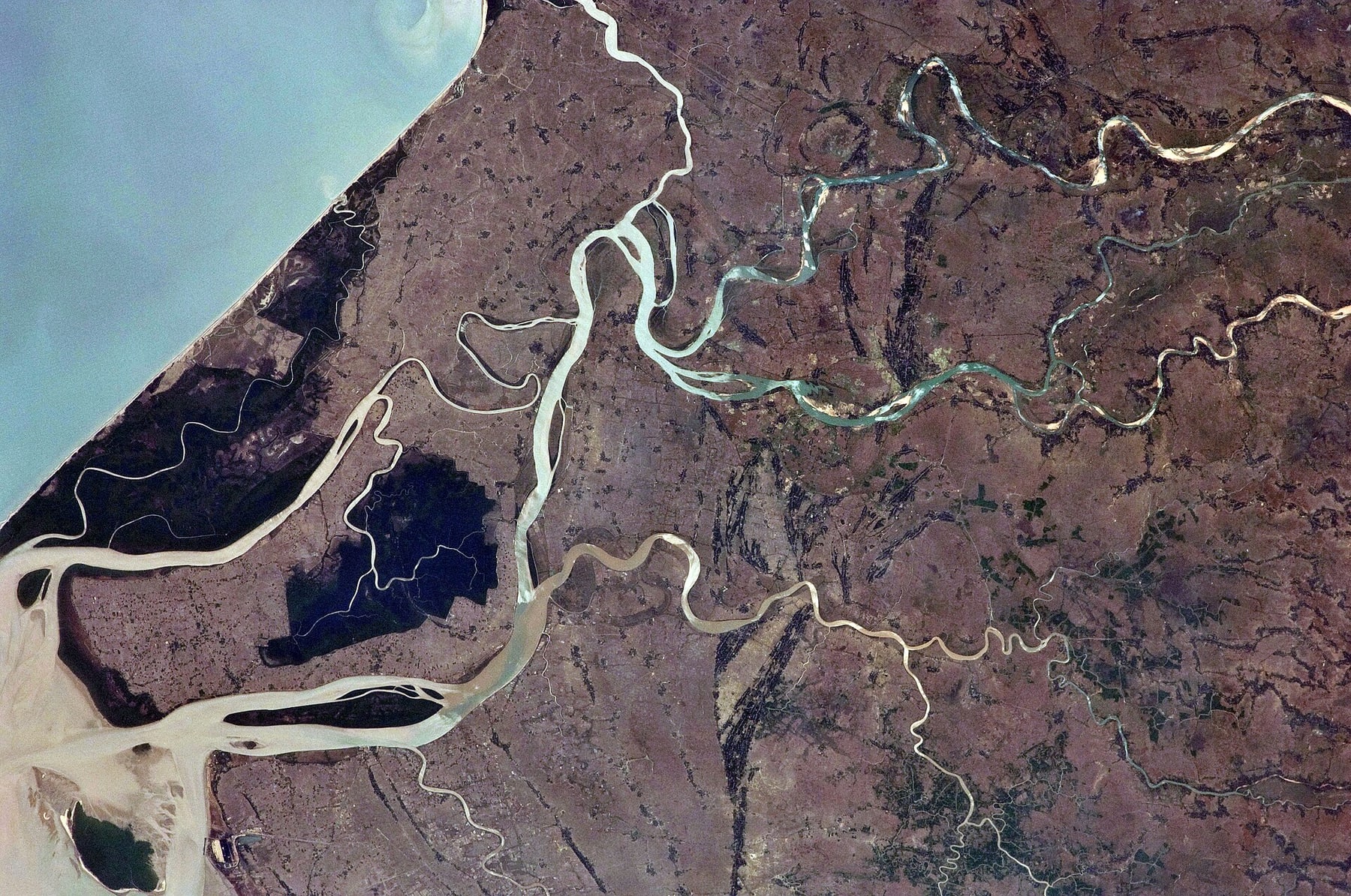 Satellite imagery shows the Brahmani River delta, mangrove belts, and beach ridges along India's east coast.